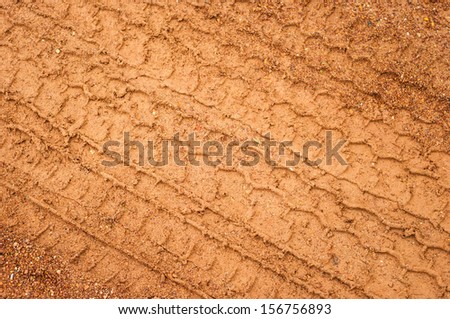 tire mark on wet  red earth,close up
