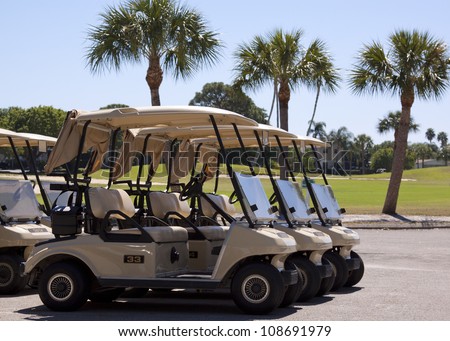 Generic club car golf carts in a parking lot in Florida.
