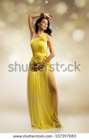 beautiful sexy young woman wearing yellow evening dress