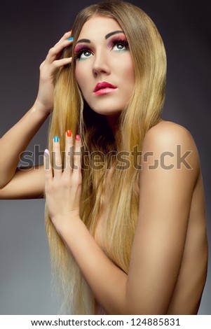 glamorous portrait of beautiful blonde girl with healthy hair colorful make up and nails.  Cosmetics