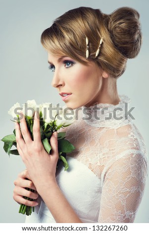 portrait of beautiful bride holding white flowers. nice make up and wedding hairstyle