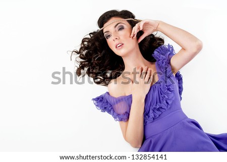 beautiful woman lying down wearing violet dress
