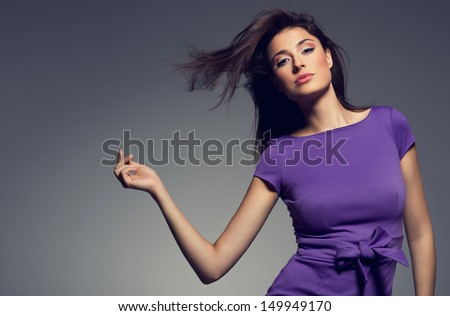 Portrait Of Beautiful Woman Wearing Purple Dress. Studio Shoot.