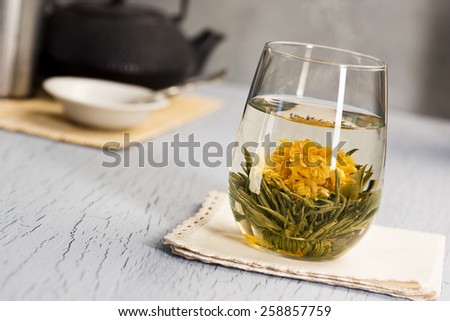 Hot Blooming Flower Tea with Teapot: as the water in the glass heats the ball of tea it opens into a flower
