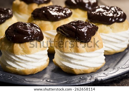 Cream Puffs, Profiteroles, or Choux Ã?Â  la CrÃ?Â¨me Covered in Chocolate Ganache on a Metal Tray