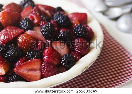 The Making of a Mixed Berry Pie: Sliced Berries Are Placed in the Uncooked Pie Shell