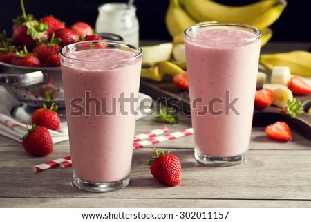 Two Strawberry Banana Yogurt Smoothies in Glasses with Ingredients