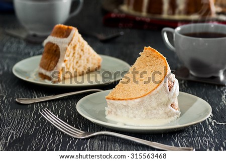 Two Pieces of Iced Cinnamon Bundt Cake with Hot Tea or Coffee