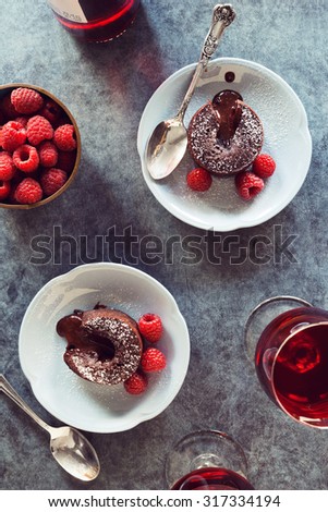 Two Baked Chocolate Lava Cakes with Raspberries and Red Wine