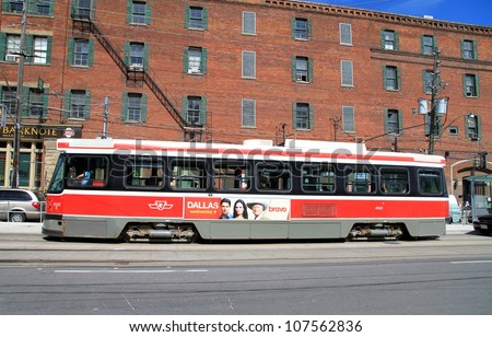 TORONTO - JUNE 29, 2012: A streetcar in a city street on June 29, 2012 in Toronto. The Toronto Transit Commission (TTC) operates 11 streetcar lines and 248 streetcars.