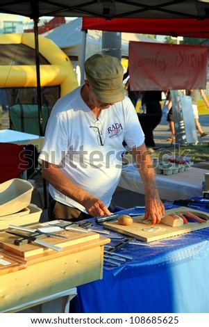 TORONTO - JULY 7: A stand advertising knives on July 7, 2012 in Toronto. The word cutler derives from \'cuteler\' and this in turn derives from Old French \'coutelier\' which comes from \'coutel\'; knife.