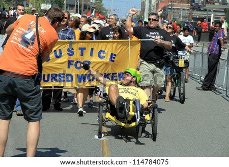 TORONTO - SEPTEMBER 3: People at the annual Labor Day Parade supporting injured workers on September 3, 2012 in Toronto. The 2012, was the 141st edition of the annual Toronto Labor Day Parade.