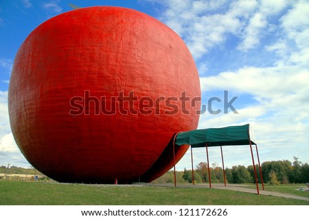 COLBORNE - OCTOBER 8: The red apple installation at the Red Big Apple pie factory on October 8, 2012 in Colborne, Ontario. The Big Apple has a height of 10.7 meters and a diameter of 11.6 meters.