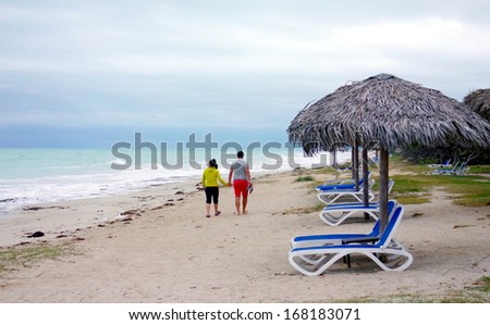 VARADERO, CUBA - NOVEMBER 28: A couple on a beach on November 28, 2013 in Varadero, Cuba. Varadero hosts every year about 1,000,000 international tourists.