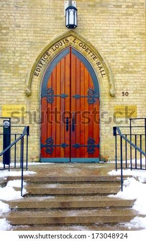TORONTO, CANADA - DECEMBER 26, 2013: The entrance of a University of Toronto historical building in a snowy Winter day.