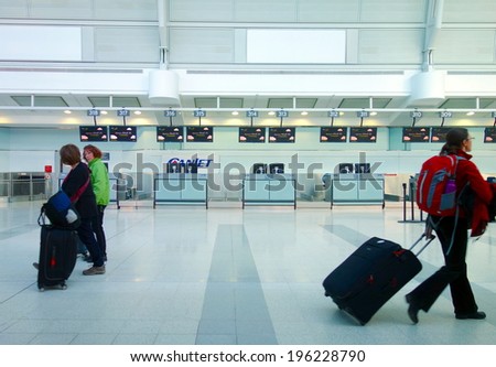 TORONTO, CANADA - APRIL 9, 2014: People carrying luggage at the Pearson Airport in Toronto, Canada.