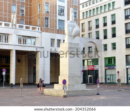 MILAN, ITALY - APRIL 26, 2014: The monument called LOVE by Maurizio Cattelan in Piazza Affari, in front of the stock exchange building, in Milan, Italy.