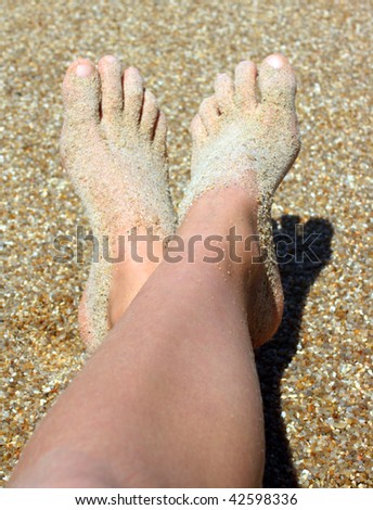 Sandy feet on a coarse beach