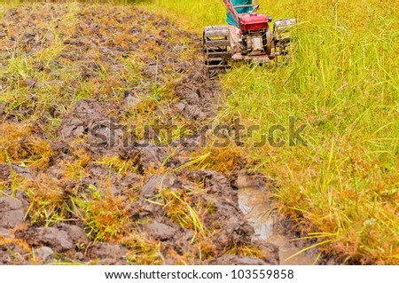 hard working farmer preparing the ground for the growth of rice in the north east of thailand