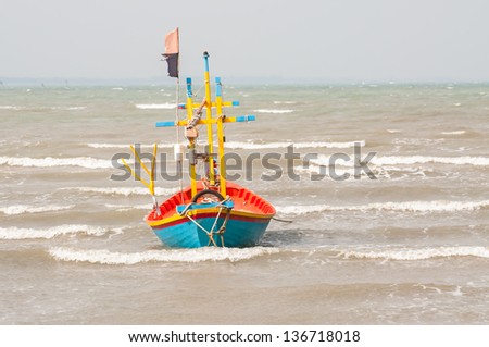 fishing boat on the beach with storm coming ,  Prachuap Khiri Khan , Thailand