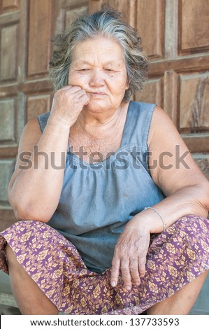 Portrait of a sad old woman with a sad nostalgic expression