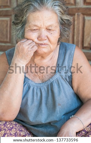 Portrait of a sad old woman with a sad nostalgic expression