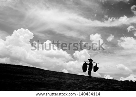 Black and white, people carrying things.