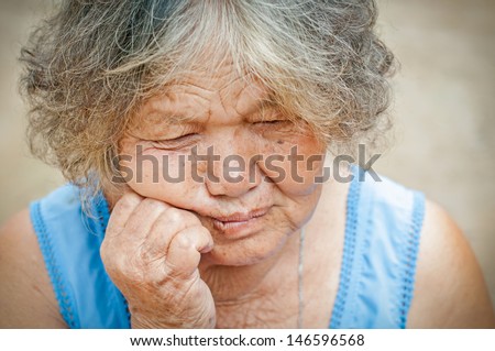 Portrait of a sad old woman with a sad nostalgic expression.