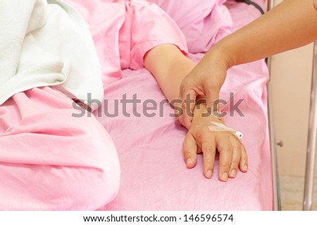 Closeup of female nurses pulse in the hands of patients in the hospital.