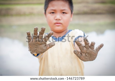 Boy hands with mud
