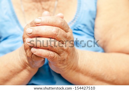 Closeup of an old woman\'s hands joined , focus on hands