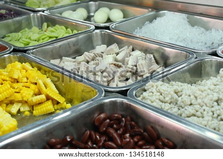 tray of assorted food for salad buffet in local market The salad in local market is most often composed of vegetable, sweet corn, boiled taro, pea or green pea, nut, cucumber,jelly,lettuce