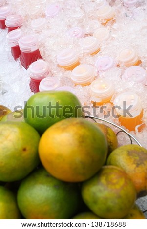 orange and chilled of bottle of ready to drink of fruit juice for sale in local market
