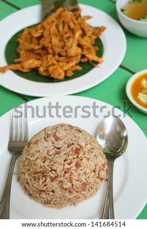 cooked organic brown rice and deep fried sajor-caju mushroom patty or mushroom cake serve with vegetable soup and its sauce