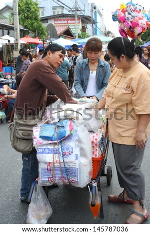 CHIANG MAI,THAILAND-JUNE 23 : a career of sale of plastic bag for any vendor that come to set their shop in Sunday walking street, It is conveniance .,On June 23, 2013 in Chiang Mai, Thailand.
