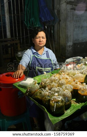 CHIANG MAI, THAILAND-OCTOBER11 : Native female merchant with her readymade food for retail sale at night time in a biggest wholesalemarket in chiang mai, On October 11, 2013, in Chiang Mai, Thailand.