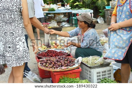 CHIANG MAI, THAILAND-APR25 : Native female merchant and her customer while doing work at a local market in chiang mai, On Apr 25, 2014, in Chiang Mai, Thailand.