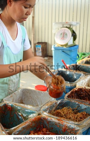 CHIANG MAI, THAILAND-APR25 : Native female merchant of pickle shop and her customer while doing work at a local yunnan market in chiang mai, On Apr 25, 2014, in Chiang Mai, Thailand.