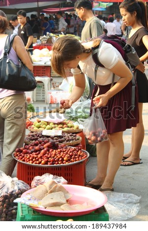 CHIANG MAI, THAILAND-APR25 : Customer while seeing seasonal fresh fruits in local market in chiang mai, On Apr 25, 2014, in Chiang Mai, Thailand.