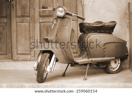 CHIANG MAI,THAILAND-FEB22 : old vespa parked in front of a house for show (post process to be sepia style picture).,On Feb 22, 2015 in Chiang Mai, Thailand.