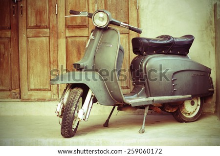 CHIANG MAI,THAILAND-FEB22 : old vespa parked in front of a house for show (post process to be vintage style picture).,On Feb 22, 2015 in Chiang Mai, Thailand.