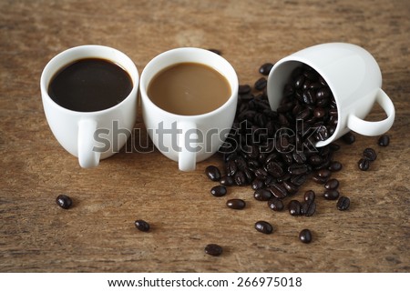 a cup of roasted coffee bean, a cup of hot black coffee, a cup of  instant coffee place on old wood background