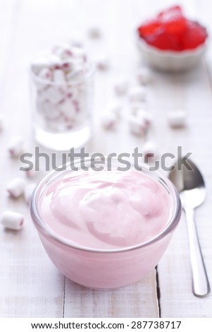 strawberry yogurt on wooden white background. strawberry yoghurt. pink yogurt.