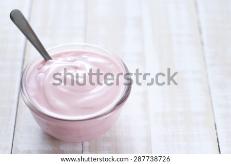 strawberry yogurt on wooden white background. strawberry yoghurt. pink yogurt.