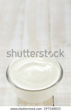 yogurt in glass cup on wooden background. plain yoghurt. yogurt. yoghurt.