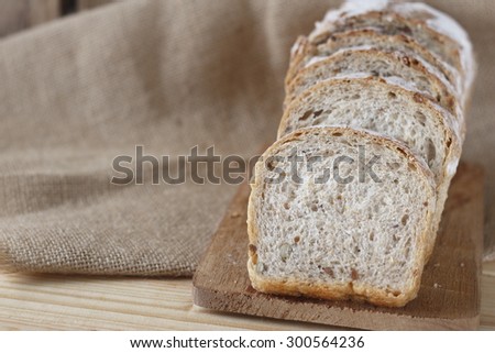 whole grain bread on wooden plate place on jute cloth. whole wheat bread.