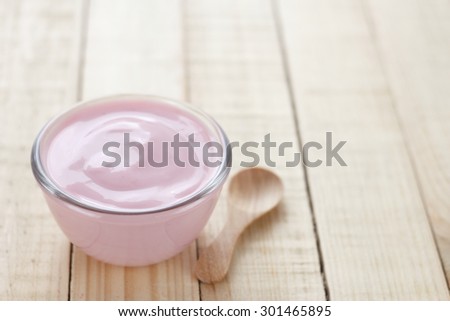strawberry yogurt on wooden background. strawberry yoghurt. pink yogurt.
