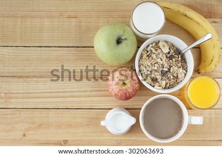 breakfast with banana cake, fruits, fruit juice, milk, coffee. healthy breakfast. breakfast on wooden background.