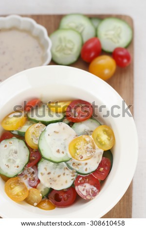 fresh sliced cucumber and sliced colorful tomato with salad dressing made from sesame and sesame oil. salad cucumber and tomato. cucumber and tomato. clean food.
