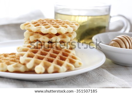 waffle with a cup of tea and honey. butter waffle cookie with tea and honey.